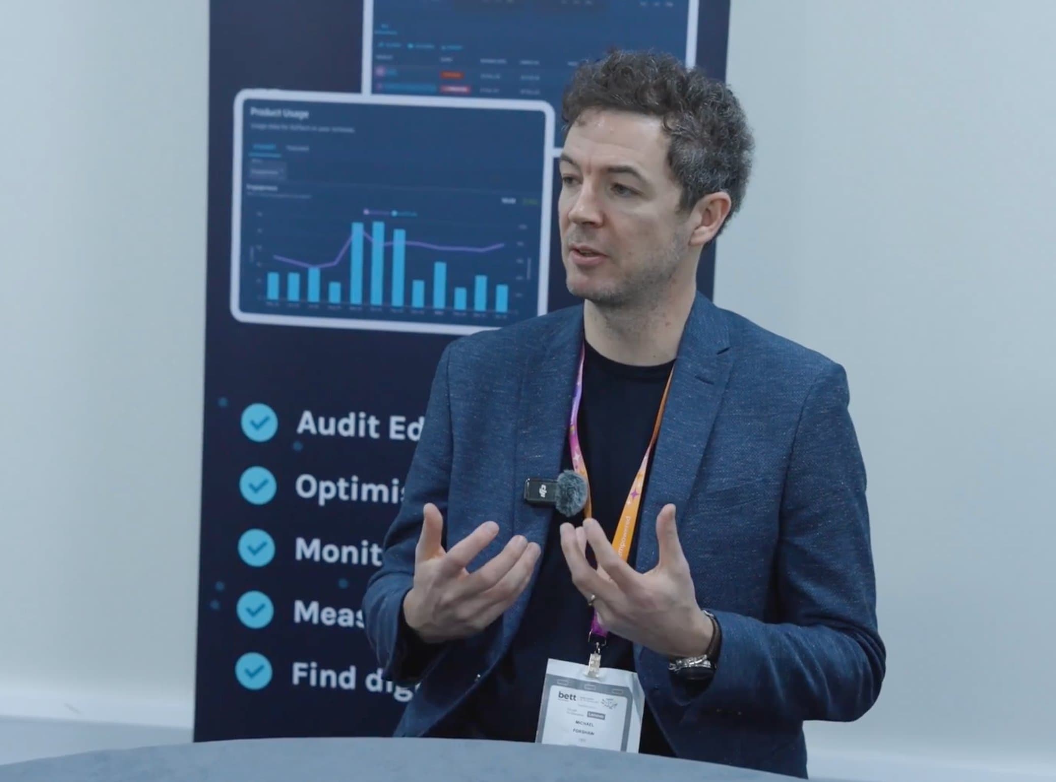 EdTech Impact CEO Michael Forshaw presenting in front of a product dashboard